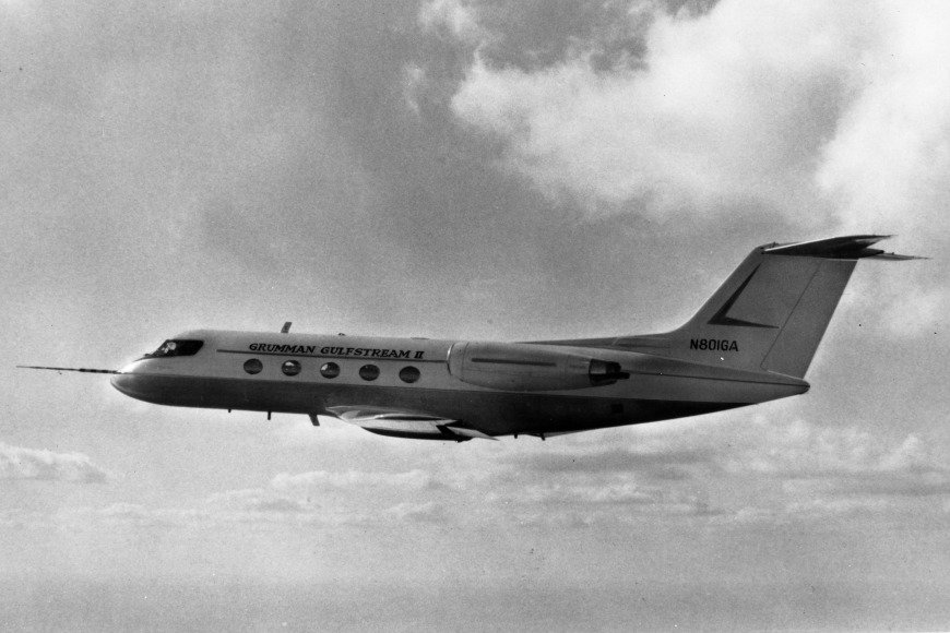 A Gulfstream II prototype, N801GA, in flight in black and white, with its engines mounted on the rear fuselage and a T-tail.