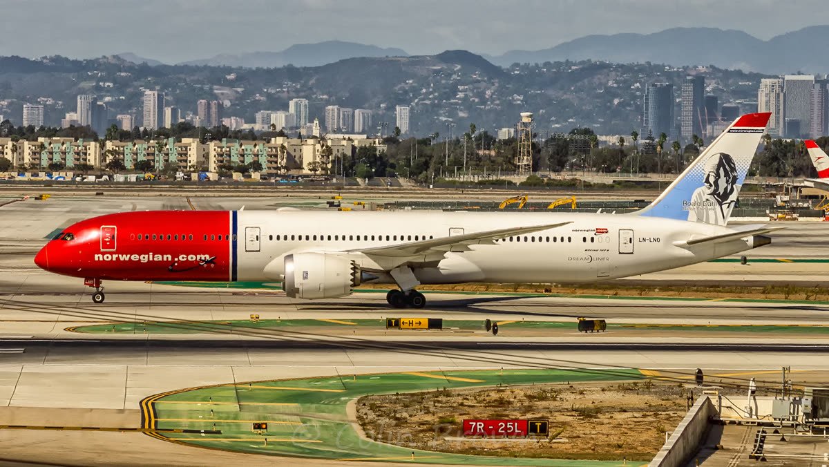 Norwegian 787-9 LN-LNO taxiing at Los Angeles in red Norwegian colours with Roald Dahl's portrait on the tail fin.