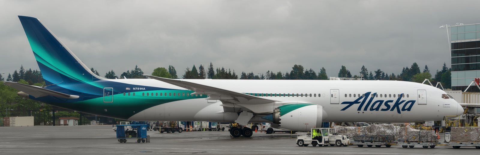 An Alaska Airlines Boeing 787-9 in the aurora-inspired Global livery, parked at Seattle.