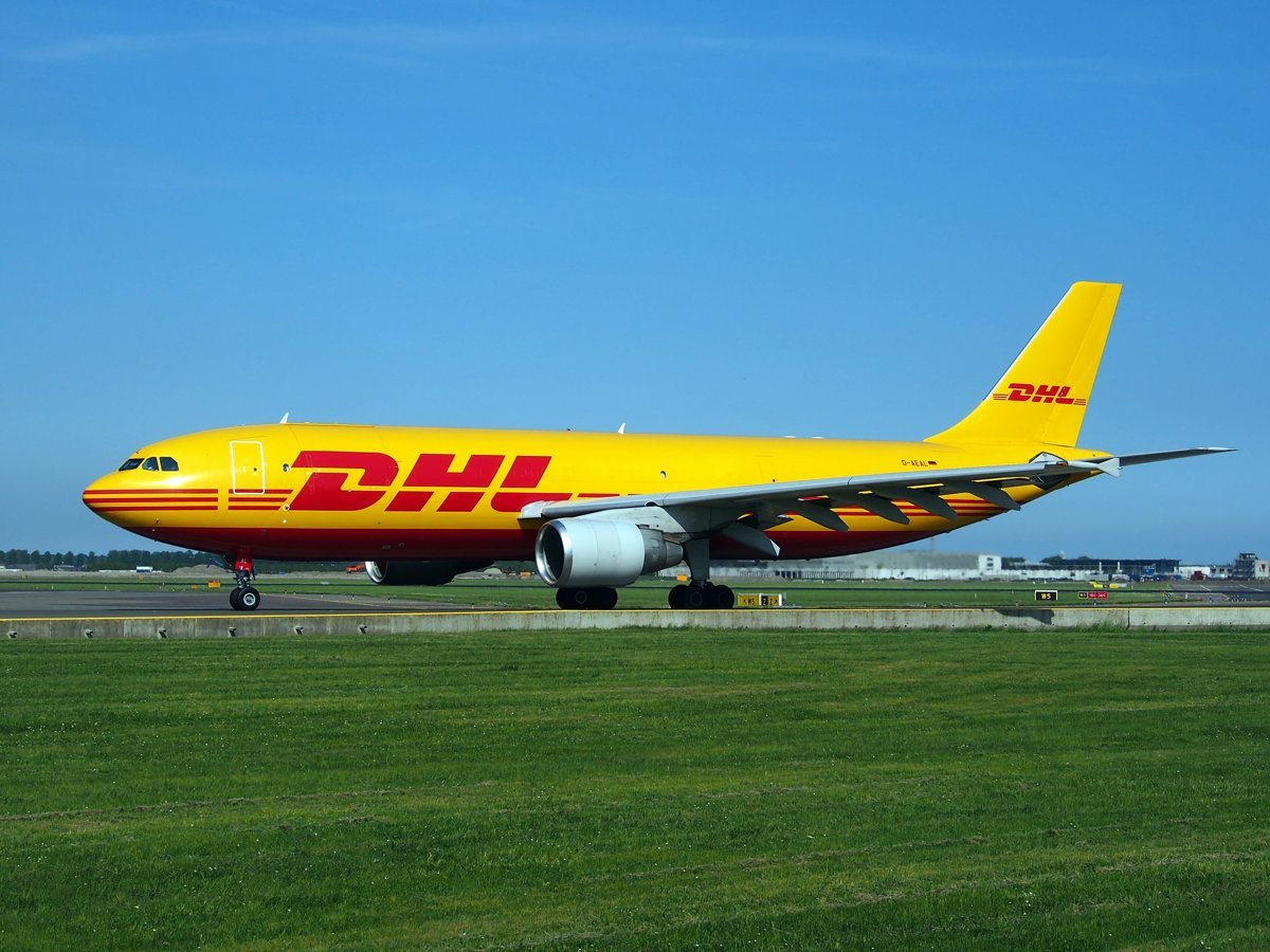 DHL-liveried Airbus A300-600 freighter D-AEAL taxiing at Amsterdam Schiphol, seen side-on.