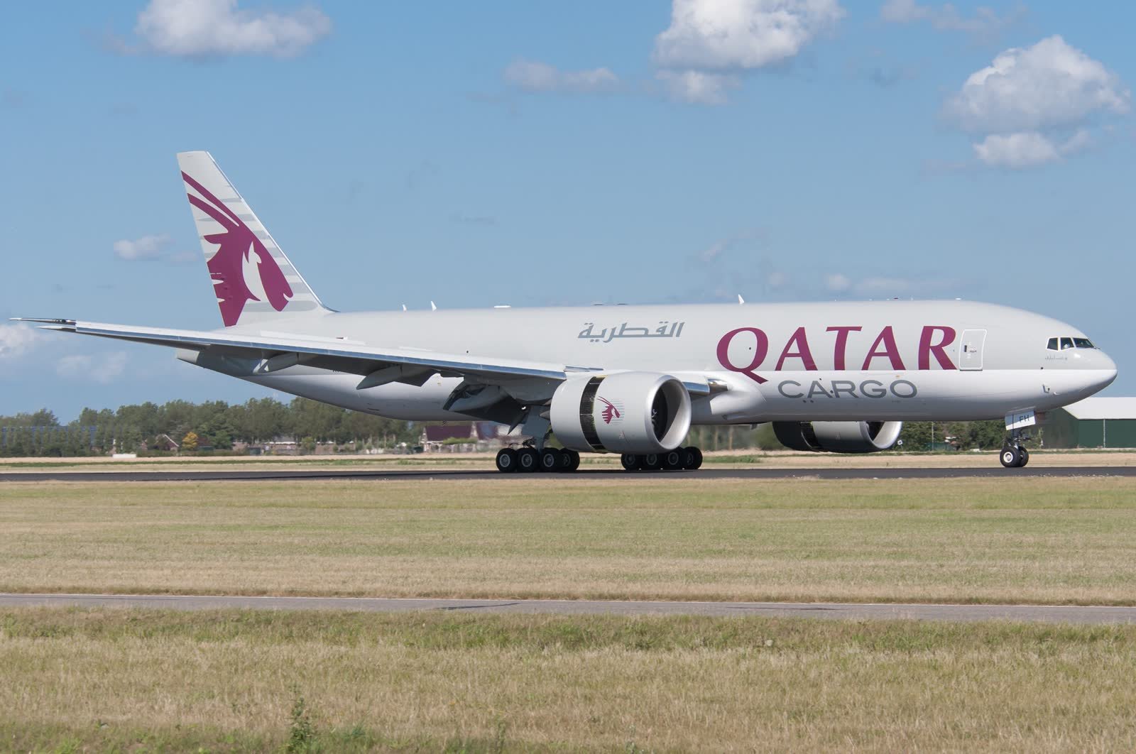 Qatar Airways Cargo Boeing 777 freighter A7-BFH on the runway at Amsterdam Schiphol, showing its windowless fuselage.
